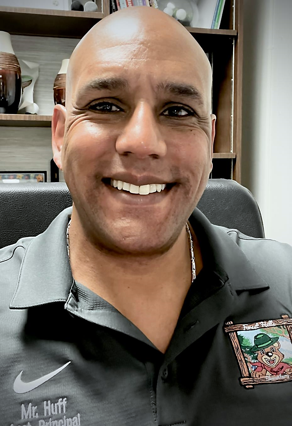 A person smiling at the cameraDescription automatically generated